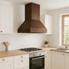 Strap-free copper range hood in IKEA-style kitchen with pale oak cabinets, quartz counters and coffee patina
