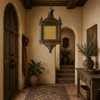 Decorative moorish pendant lamp in a rustic entryway with timber beams and textured walls