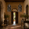 Mexican tin lantern with starburst and floral cutout patterns in an old-world entryway