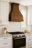 Large custom hammered copper kitchen range hood in transitional kitchen, sculptural copper canopy above balanced cabinetry and refined stone surfaces