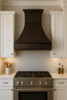 Hammered under-cabinet copper 30 x 42 inch stove hood in a transitional kitchen with tall tapered bell shape and banded trim