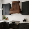 Wall-mount copper kitchen range hood with riveted straps in a contemporary kitchen