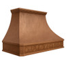Hammered copper exhaust hood angled view on white background with grapevine apron, molded crown, and gently sloped body