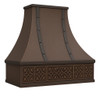 Spanish Colonial Revival copper range hood angled view, hammered canopy with warm patina and decorative apron detailing