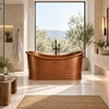 Freestanding hand hammered copper bathtub in a contemporary spa with natural stone, neutral tones and abundant light