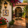 Talavera tile plaque number five with Mexican floral border featured in a Spanish courtyard with warm architectural accents