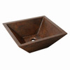 Angled view of a double wall rectangular copper vessel bathroom sink with tapered sides and drain located on the center