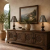 Punched tin cone shade with rosette cutouts on a mediterranean sideboard with warm decor