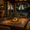 Two glass-stone studded punched tin cone pendant shades over a covered patio dining table