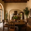 Two glass-stone studded punched tin cone pendant shades in a warm hacienda dining room