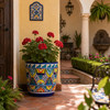 Mexican talavera pot with colorful floral pattern decorating a sunlit Spanish patio