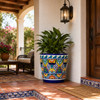 Mexican talavera pot with colorful floral pattern displayed on a covered porch