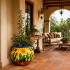 Talavera flower planter with desert sun and cactus design on a covered porch