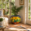 Talavera flower planter with desert sun and cactus design in a bright sunroom