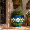 Talavera garden flower planter with white lily motifs on a rustic terrace