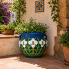 Talavera garden flower planter with white lily motifs in a Mediterranean garden
