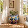 Hand-painted talavera planter with cobalt rim and floral lattice in a sunlit sunroom