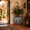 Hand-painted talavera planter with cobalt rim and floral lattice in a hacienda entryway