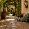 Hand-painted flower planter with blue green scrolls – Dolores Hidalgo design along a garden walkway