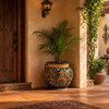 Talavera planter with caramel scrollwork and rolled rim in a hacienda entryway