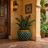 Hand painted talavera planter with green scallop pattern in a warm hacienda entryway