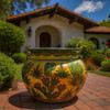 Talavera flower pot with cactus desert design decorating a walkway of a backyard of Mexican hacienda style house