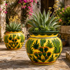 Colorful cactus talavera planter surrounded by succulents in a Mediterranean garden