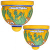 Two Mexican talavera wall sconces with cactus and yellow desert design on white