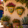 Cactus talavera wall sconces with flowering plants displayed on a sunny garden wall