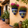 Yellow medallion talavera wall sconces with flowers in a colorful Mexican courtyard