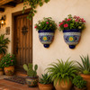 Pair of cobalt blue talavera wall sconces with plants beside a hacienda entryway