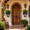 Pair of lattice talavera wall sconces with flowers beside a rustic hacienda entryway