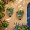 Pair of floral talavera wall sconces decorating a Mediterranean garden seating area