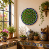 Green mandala decorative talavera plate with navy geometric accents near a sunny window