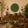 Green mandala decorative talavera plate with navy geometric accents in a dining room