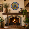 Sky blue floral decorative talavera plate with traditional Mexican design featured above a rustic hacienda fireplace mantel