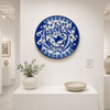 Blue floral bird decorative talavera plate traditional Mexican design presented in a clean white gallery display setting