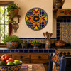 Orange scroll decorative talavera plate with cobalt geometric pattern decorating a traditional Mexican kitchen with colorful accents
