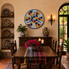 Bird floral decorative talavera plate with blue lattice pattern decorating a warm Spanish dining room with rustic furnishings