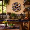 Bird floral decorative talavera plate with blue lattice pattern displayed on a colorful wall in a traditional Mexican kitchen setting