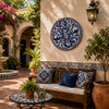 Blue bird decorative talavera plate with floral vine design featured in a sunny Mediterranean courtyard with classic décor