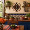 Blue medallion decorative talavera plate with yellow lattice design displayed on a colorful Mexican kitchen wall with artisan decor accents