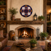 Cobalt rim decorative talavera plate with red floral lattice design mounted above a rustic fireplace as a decorative focal point