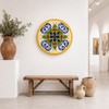 Yellow rim decorative talavera plate with blue floral cross design presented in a bright white gallery with clean surroundings
