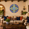 Blue floral decorative talavera plate with green scrollwork pattern featured in a hacienda living room with wooden beams and artisan décor