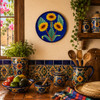 Sunflower decorative talavera Pplate with cobalt blue background displayed on a colorful Mexican kitchen wall with rustic wood accents