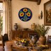 Sunflower decorative talavera Pplate with cobalt blue background decorating a traditional Spanish dining room with elegant furnishings