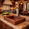 Over-the-counter hammered apron copper bar sink in a Spanish Colonial style kitchen