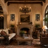 Two hacienda sunburst tin wall sconces with scrolls in a hacienda living room with rustic decor