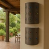 Rustic tin lamp shade with glass accents decorating veranda wall